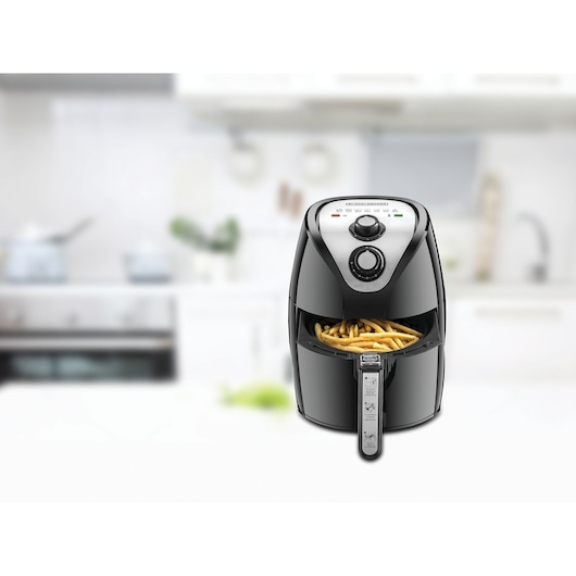 BLACKDECKER AF200 air fryer with fries in kitchen setting, front angle.