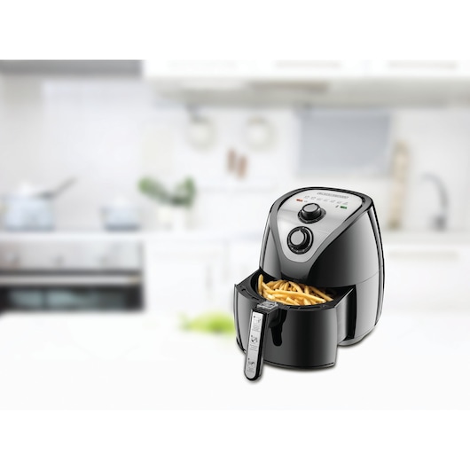 Photo of BLACKDECKER AF200 air fryer with open basket showing cooked fries, black finish, kitchen background.