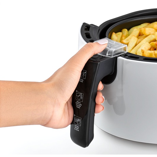 BLACKDECKER AF220 air fryer close-up with hand holding black handle, basket filled with French fries, white background.