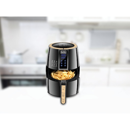 BLACK+DECKER AF400 air fryer with digital display, drawer open showing fries, on kitchen counter.