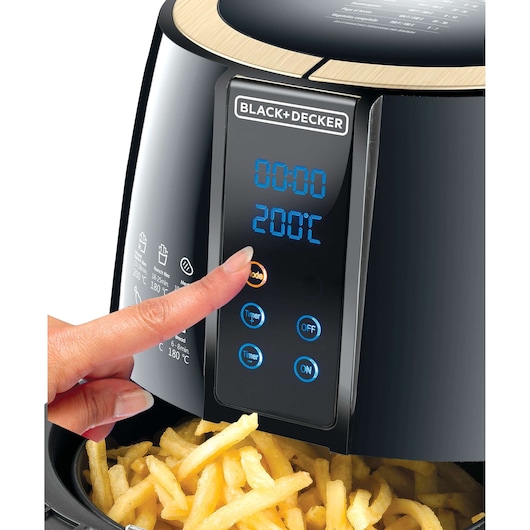 BLACK+DECKER AF400 air fryer with digital display, fries in basket, hand pressing mode button, front view.