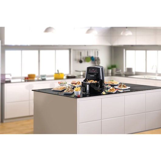 BLACKDECKER AF600 air fryer with food on plates, kitchen countertop, front angle.