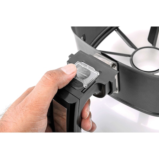 Photo of a hand attaching the BLACKDECKER AF600 part to a black plastic device, close-up view on white background.