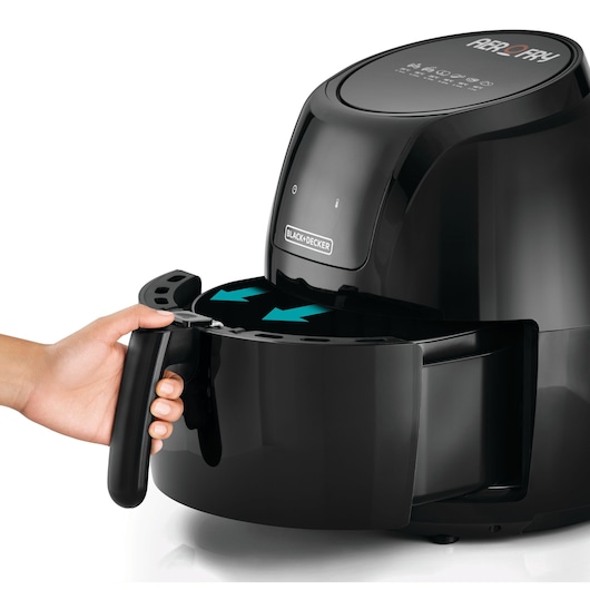 BLACK+DECKER AF625 air fryer with a hand pulling out the black cooking basket, side angle on white background.
