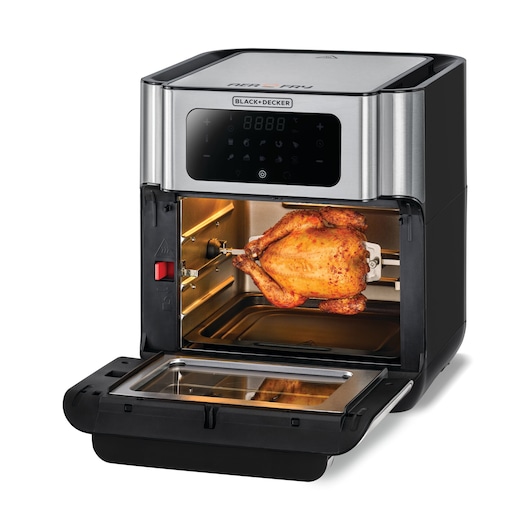 A BLACK+DECKER air fryer oven with its door open, showing a cooked whole chicken on a rotisserie spit inside.