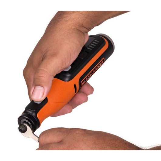 Photo of BLACK+DECKER BCRT8IK orange and black rotary tool in use, close-up of hands operating tool.