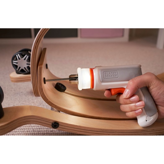 BLACKDECKER BCRTA01 cordless screwdriver with LED light assembling wooden furniture, close-up view.