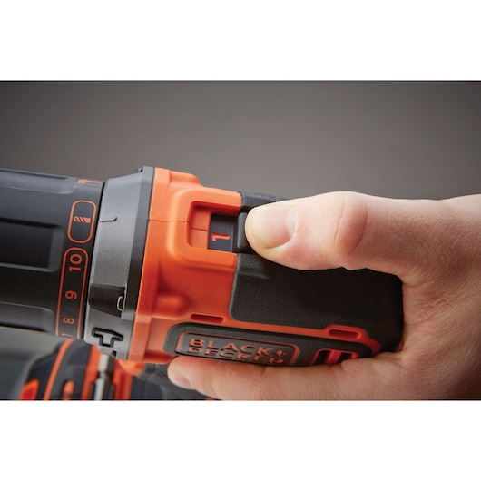 Photo of a hand adjusting BLACK+DECKER BDCHD18KST cordless drill, focusing on the speed selector switch.