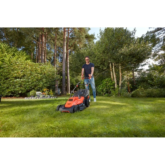 Photo of BLACKDECKER BEMW481BH lawn mower in use on green grass outdoors.