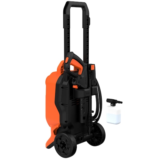 A BLACK+DECKER pressure washer with an orange and black design, large wheels, a movable handle, and a spray gun attachment. A separate detergent bottle and nozzle are placed beside it.