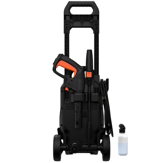 A BLACK+DECKER pressure washer with a handle, wheels, and accessories including a spray gun and lance, shown upright with a detergent bottle beside it.