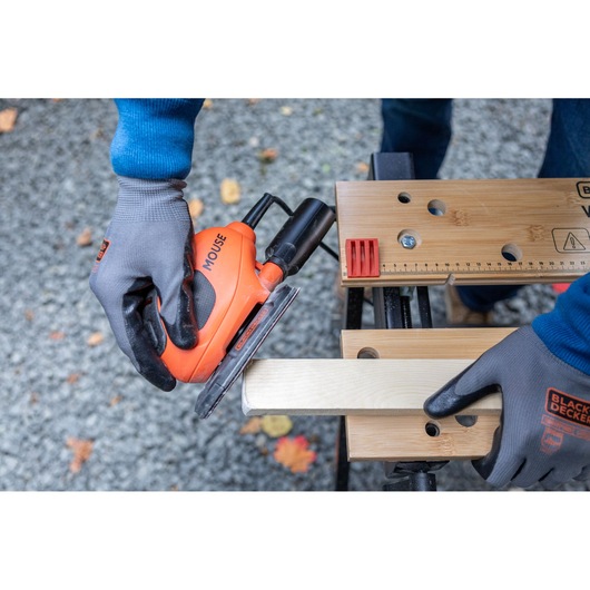 BLACKDECKER BEW230 orange mouse sander in use on wood, close-up, photography.