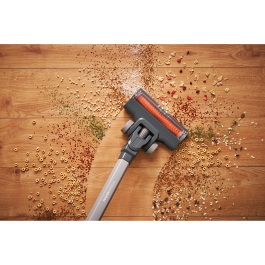 BLACKDECKER BHFEA520J stick vacuum cleaning debris from wooden floor, top view photography