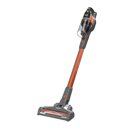 A BLACK+DECKER cordless stick vacuum cleaner with an orange and black design, featuring a clear dust container and upright handle.