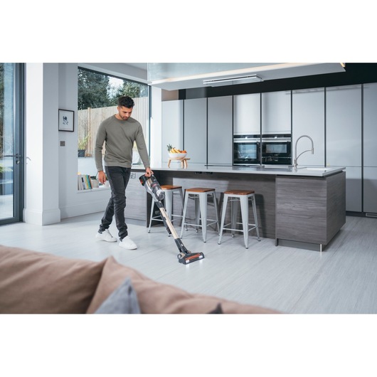BLACKDECKER BHFEV36B2D cordless stick vacuum in use on modern kitchen floor.