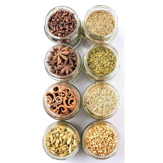 BLACKDECKER BX390 photography of assorted spices in glass jars, top view, on white background.