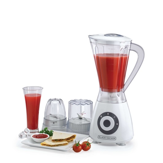 Photo of BLACK+DECKER BX390 blender with two containers, glass of red juice, prepared food, and tomatoes, front angle.