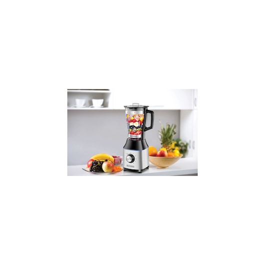 BLACKDECKER BX650G blender with fruit in jar on kitchen counter, near fruit bowls, front angle.