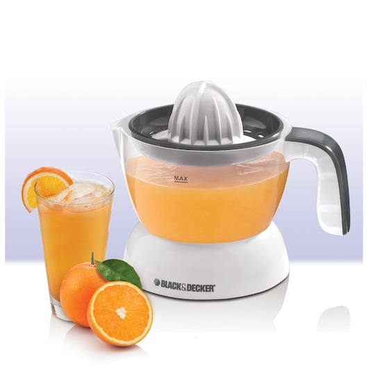 Photo of BLACK+DECKER CJ200 citrus juicer with transparent container, next to a glass of orange juice and fresh oranges, front angle.