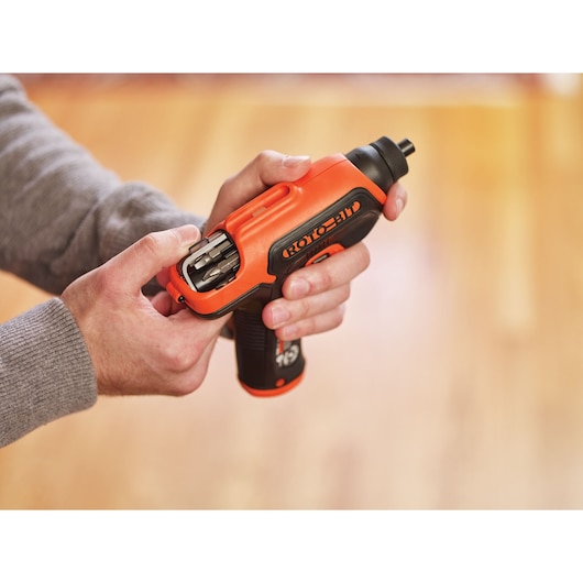 Photo of BLACK+DECKER CS36BSCROTO cordless screwdriver with bit storage, held in hand indoors.