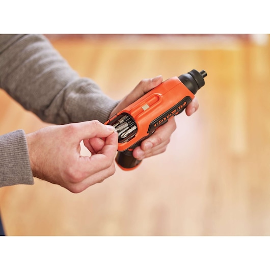 Photo of BLACKDECKER CS36BSCROTO cordless screwdriver in use, orange tool with integrated bit storage.