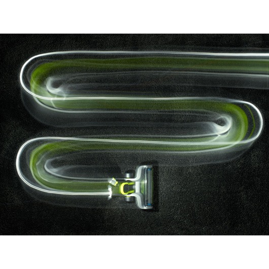 BLACKDECKER CUA525BHA cordless vacuum cleaner top view showing cleaning path on black carpet, motion blur effect.