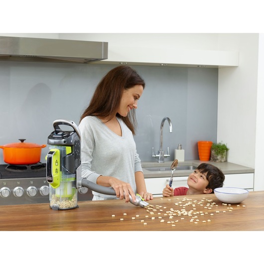 BLACKDECKER CUA525BHA vacuum cleaner used on a kitchen counter to clean cereal spill.