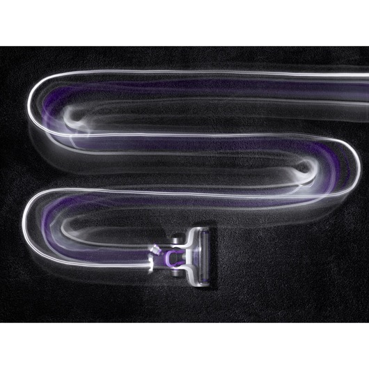 BLACKDECKER cordless stick vacuum CUA525BHP in motion, leaving light trails on black carpet, top view.