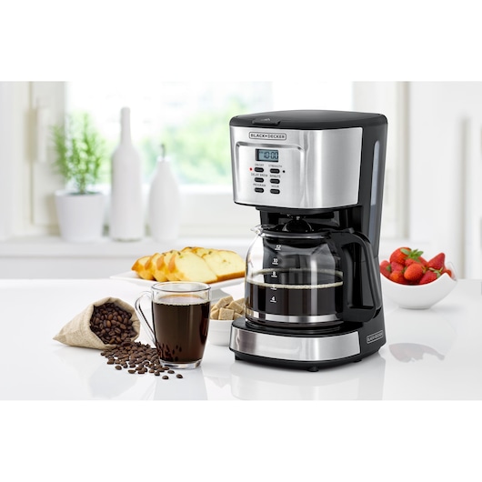 BLACKDECKER DCM85 coffee maker with digital display, glass carafe, and black-silver finish on kitchen counter.