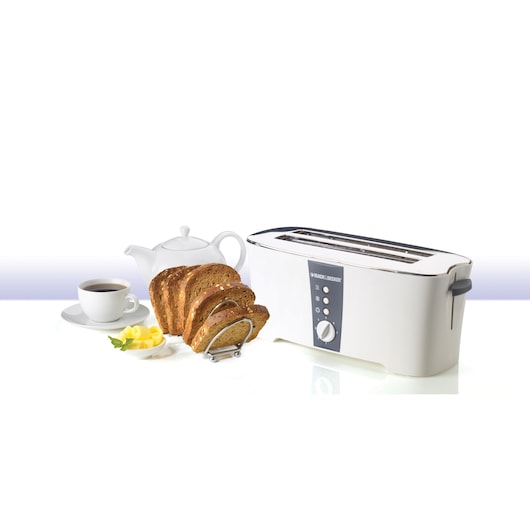 BLACK+DECKER ET124 white long slot toaster front angle with four slices of bread, teapot, and cup of coffee.