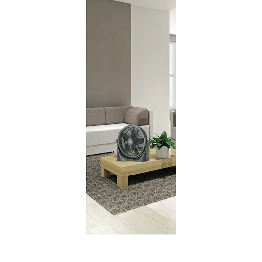 BLACKDECKER FB1620SA table fan on wooden coffee table in modern living room setting.