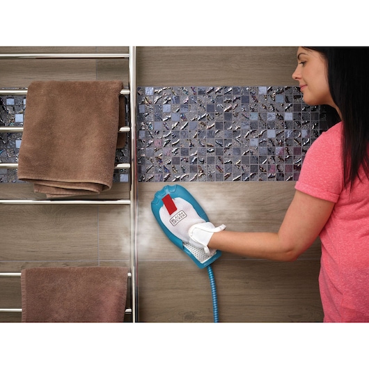 BLACKDECKER FSH10SMP steam cleaning glove used on tiled wall in bathroom setting.