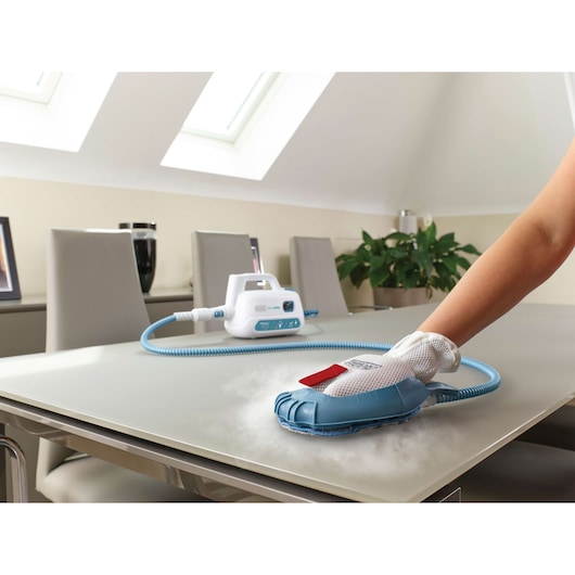 BLACKDECKER FSH10SMP steam cleaning glove cleaning tabletop in modern dining room, close-up angle.