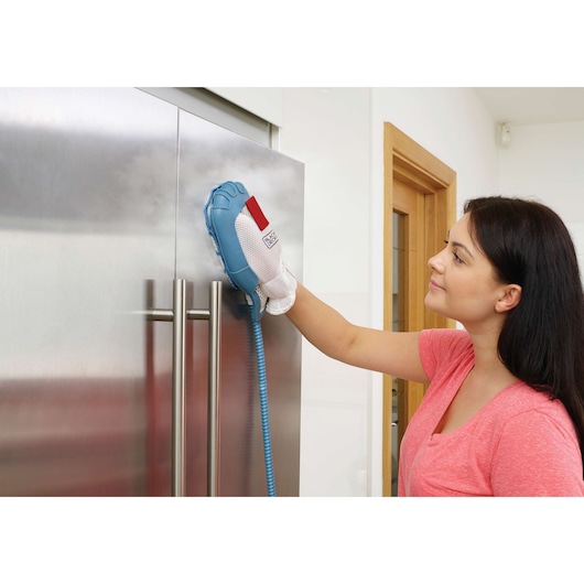 BLACKDECKER FSH10SMP steam cleaning glove used on stainless steel kitchen fridge door.