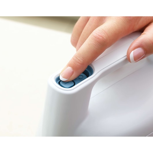 BLACKDECKER FSH10SMP handheld appliance close-up with finger pressing blue power button.