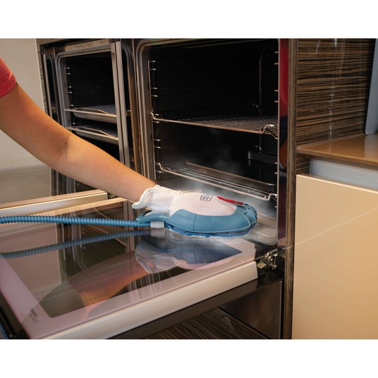 BLACKDECKER FSH10SM steam cleaning glove used on an oven door, close-up view.