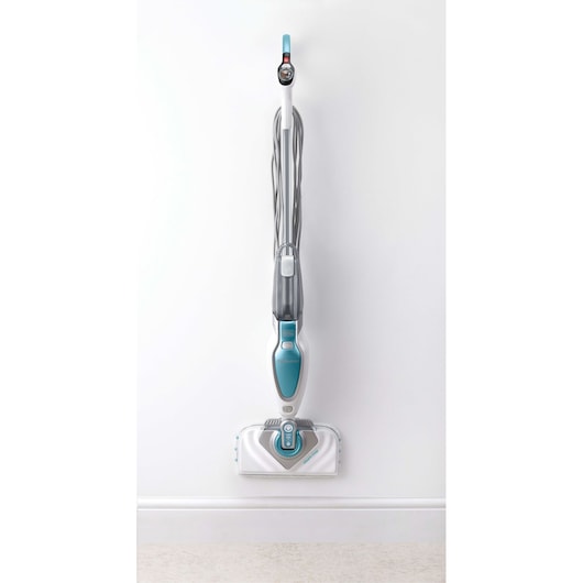 A BLACK+DECKER steam mop with a blue and white design, standing upright against a white wall.