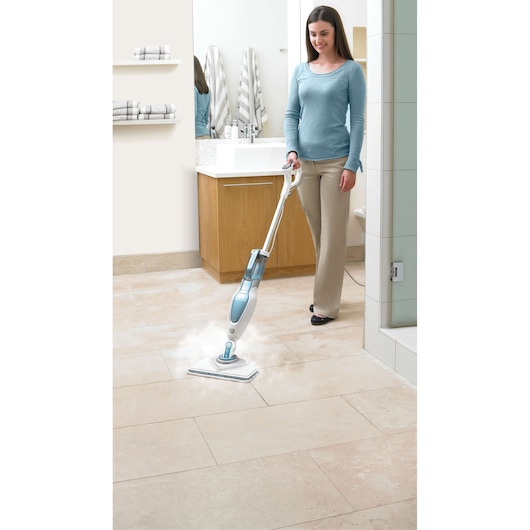 BLACKDECKER FSM1630 steam mop cleaning beige tile floor in bathroom setting.