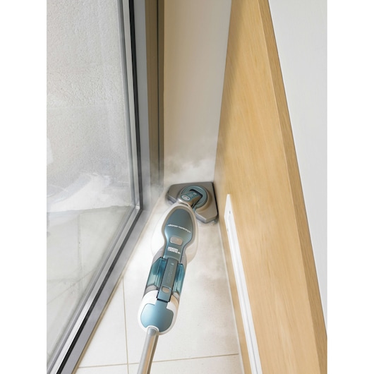 BLACKDECKER FSM1630 steam mop cleaning corner tile floor near window and wall.