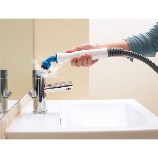 BLACKDECKER FSMH1321 steam cleaner nozzle cleaning bathroom faucet, close-up photo.