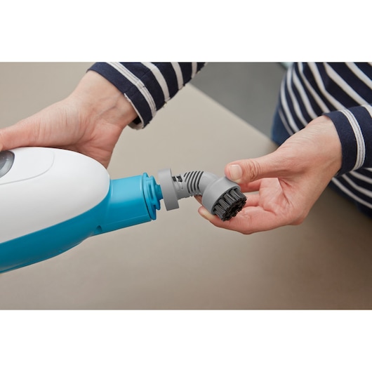 BLACKDECKER FSMH13E5 steam mop accessory brush attachment held in hand, close-up photography.
