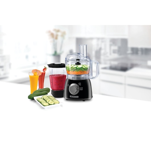 BLACKDECKER FX400B food processor with blender jar and sliced vegetables, front view on kitchen counter.