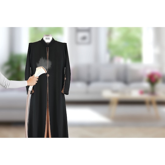 BLACKDECKER GST1600 handheld garment steamer being used on a black dress in a living room, product front view.