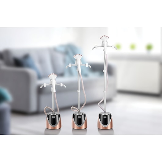 BLACKDECKER GST1600 garment steamers in three heights shown in a modern living room setting.