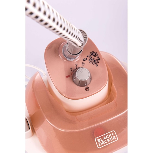 BLACK+DECKER GSTM2050 garment steamer top view showing adjustable dial and flexible hose, pink finish.