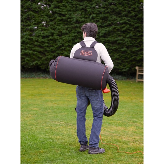 Photo of BLACK+DECKER GW3031BP garden vacuum and blower worn as a backpack, outdoor view, rear angle.