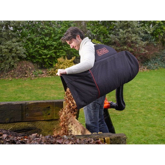 Photo of BLACKDECKER GW3031BP garden leaf collection bag emptying leaves outdoors.