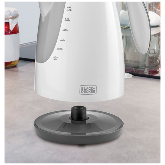 BLACKDECKER JC72 white electric kettle with gray base on a kitchen countertop, side angle.