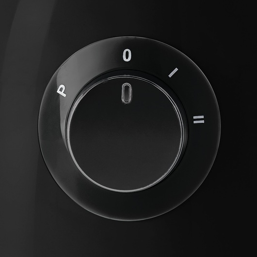 BLACK+DECKER KR42 black control dial with white settings on glossy surface, close-up angle.
