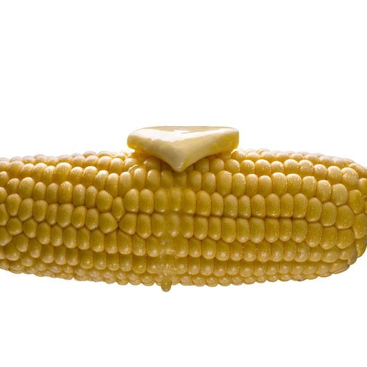 BLACKDECKER MK100 photography of corn on the cob with melting butter, side angle, white background.